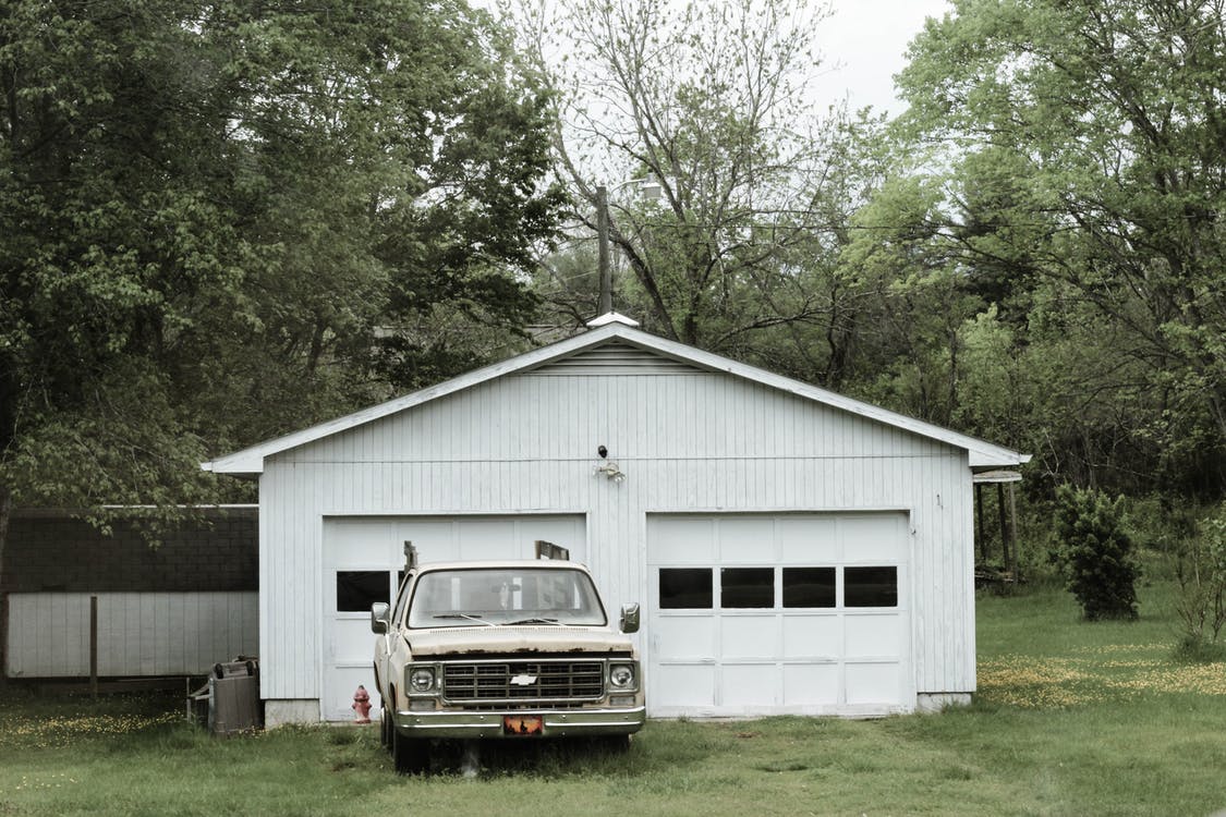 Classic White Chevrolet Pickup Truck Near White 2-door Garage Near Trees