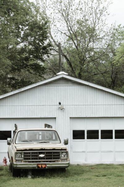Classic White Chevrolet Pickup Truck Near White 2-door Garage Near Trees